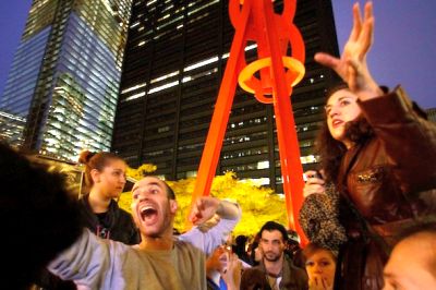 Occupy Wall Street activists Eric Linkser, center left, and Cecily McMillan, far right, take turns shouting information to fellow protesters preparing to return to Zuccotti Park on Nov. 15, 2011. AP/Bebeto Matthews